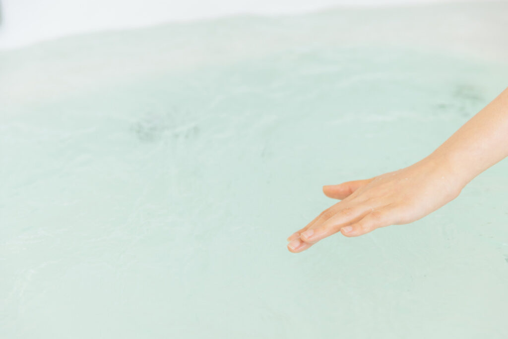 浴槽のお湯の温度を確かめるイメージ